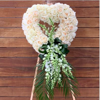 All white heart shape funeral flowers on stand. Funeral flower wreath heart chicago flower delivery.